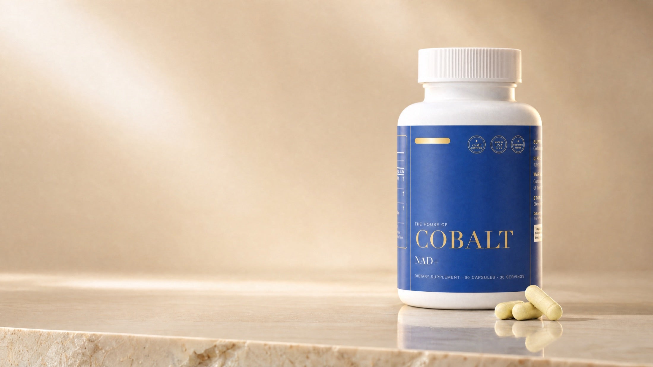 A House of Cobalt NAD+ bottle on a marble shelf in warm light