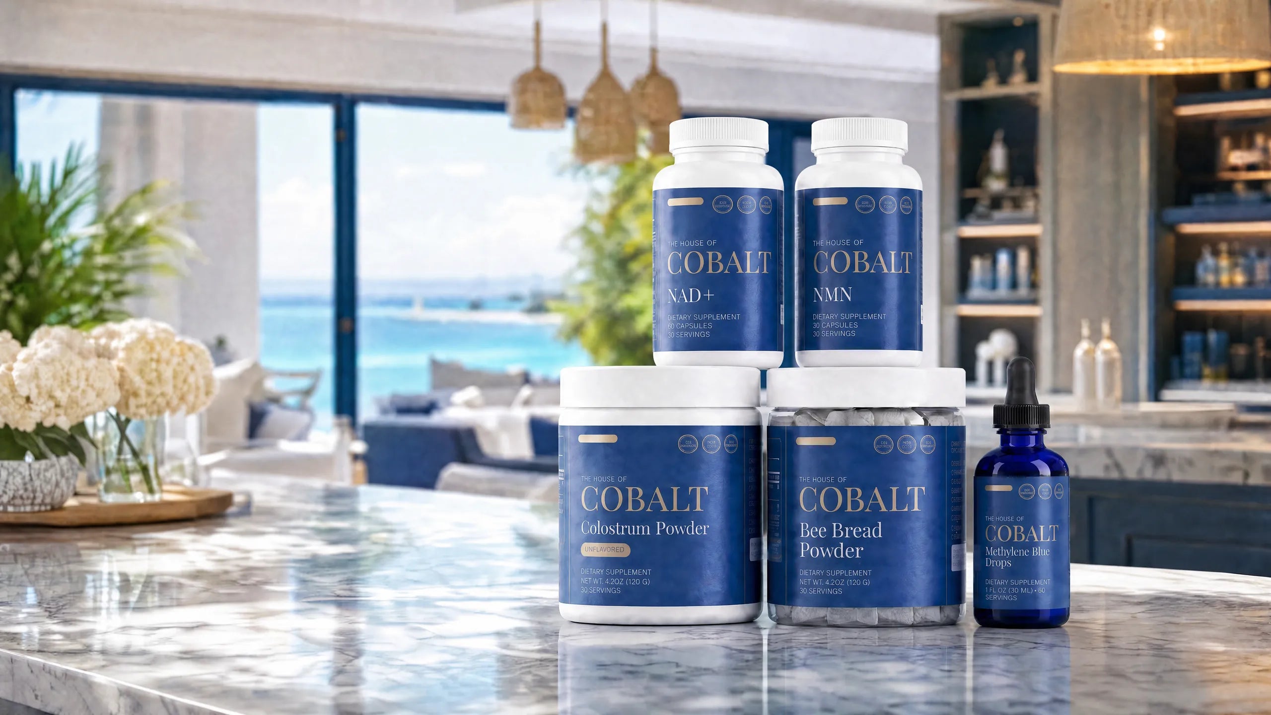 The House of Cobalt collection — NMN, NAD+, Colostrum, Bee Bread, Reishi gummies and Methylene Blue on a kitchen counter